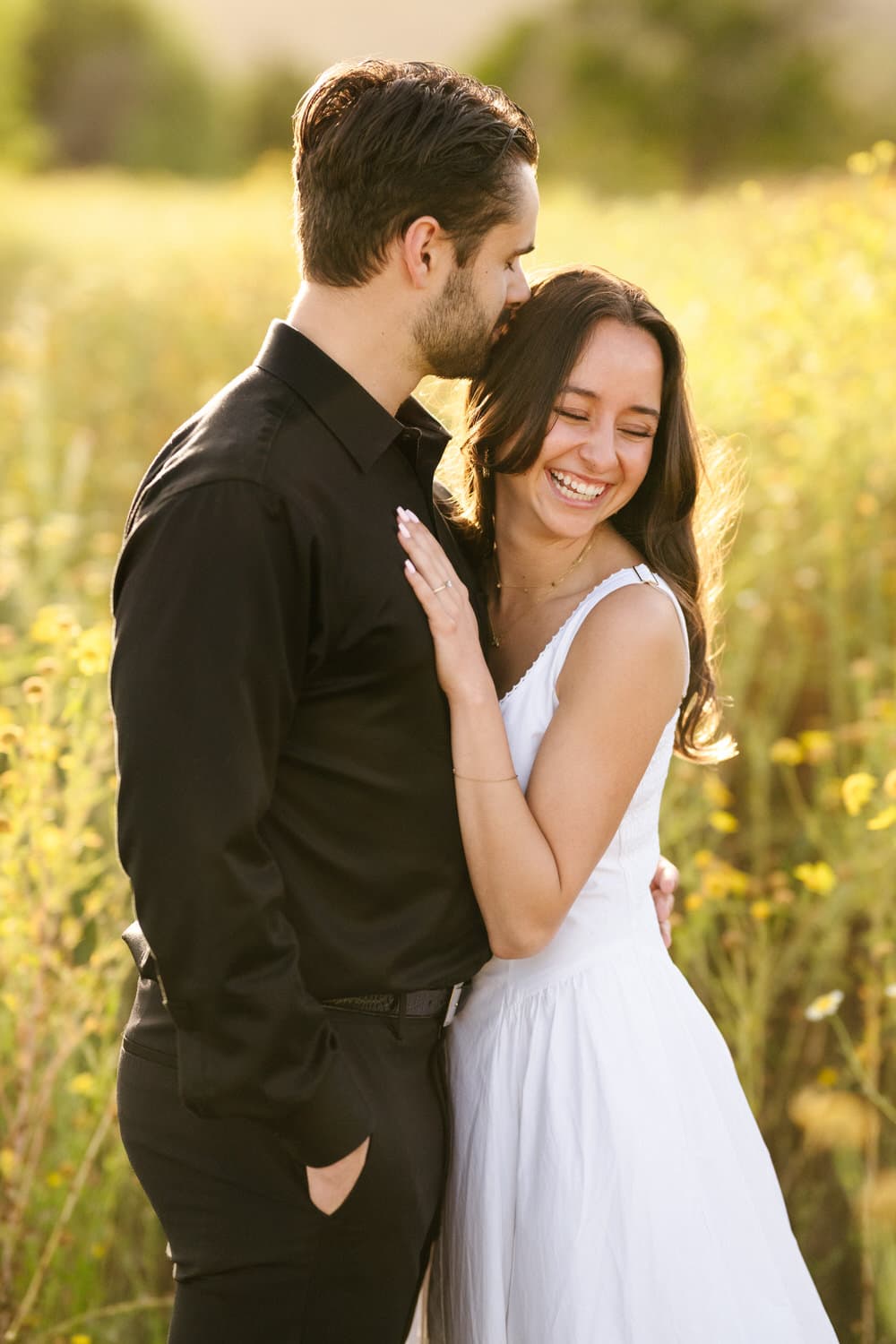 A couple embracing in a wildflower field